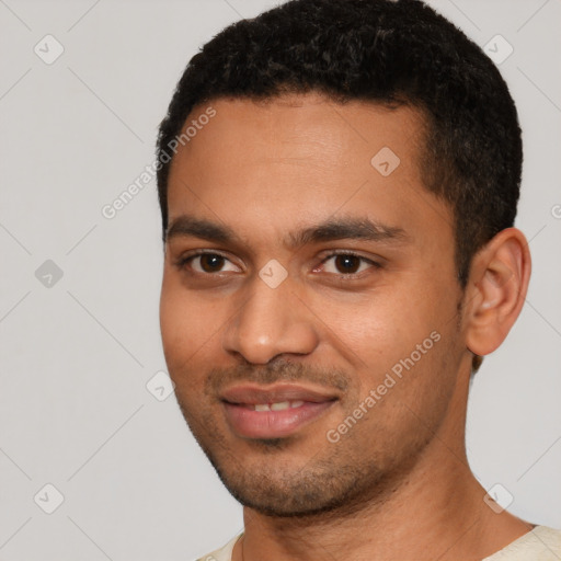 Joyful black young-adult male with short  black hair and brown eyes