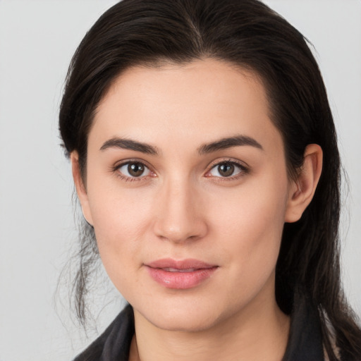 Joyful white young-adult female with long  brown hair and brown eyes