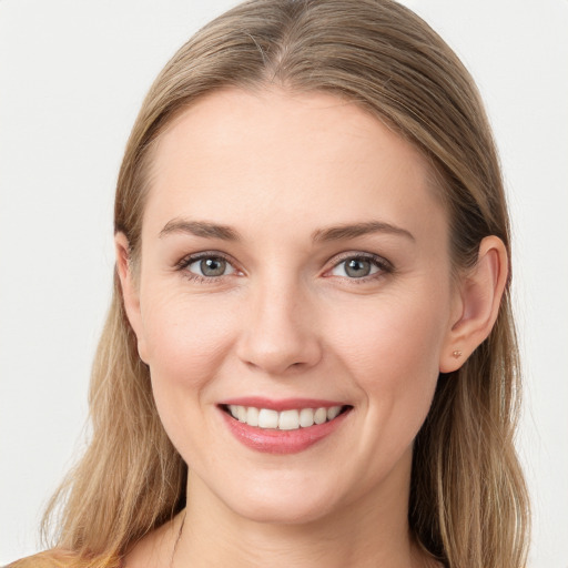 Joyful white young-adult female with long  brown hair and blue eyes