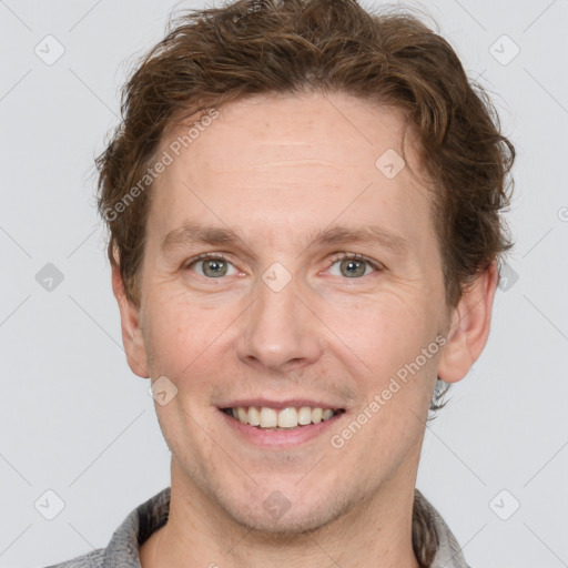 Joyful white adult male with short  brown hair and grey eyes