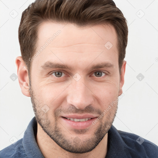 Joyful white young-adult male with short  brown hair and grey eyes