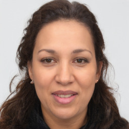 Joyful white adult female with long  brown hair and brown eyes