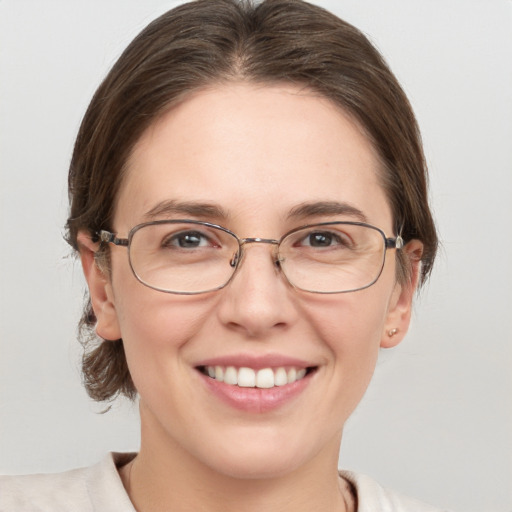 Joyful white adult female with medium  brown hair and grey eyes