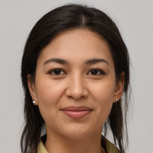 Joyful latino young-adult female with long  brown hair and brown eyes