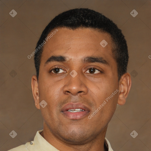 Joyful latino young-adult male with short  brown hair and brown eyes