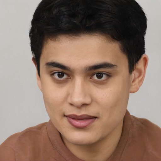 Joyful latino young-adult male with short  brown hair and brown eyes
