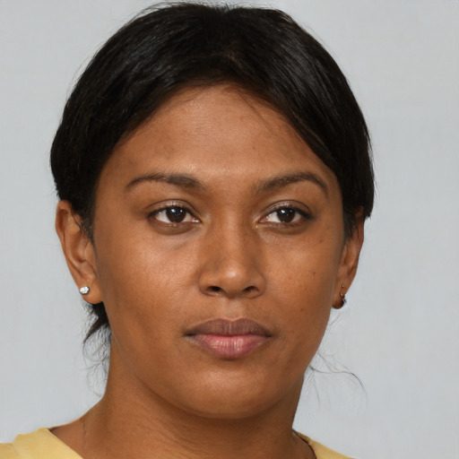 Joyful black young-adult female with short  brown hair and brown eyes