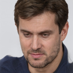 Joyful white adult male with short  brown hair and brown eyes