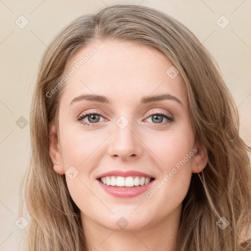 Joyful white young-adult female with long  brown hair and blue eyes