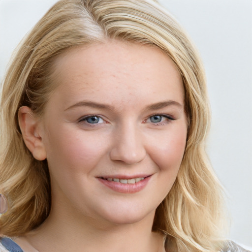 Joyful white young-adult female with long  brown hair and blue eyes