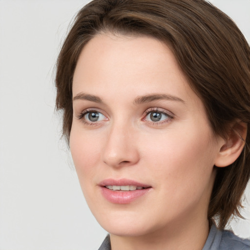 Joyful white young-adult female with medium  brown hair and blue eyes