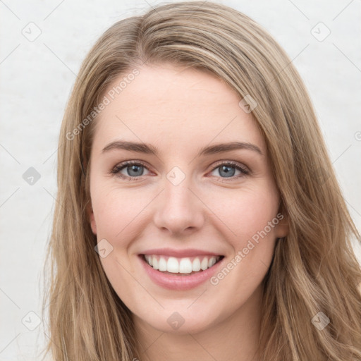 Joyful white young-adult female with long  brown hair and green eyes