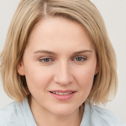 Joyful white young-adult female with medium  brown hair and blue eyes