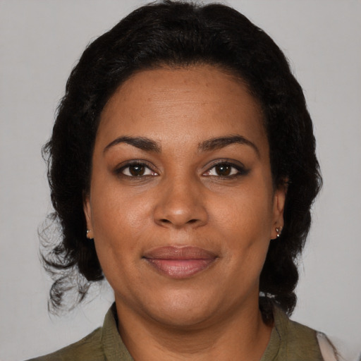 Joyful black adult female with medium  brown hair and brown eyes