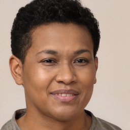 Joyful latino young-adult male with short  brown hair and brown eyes