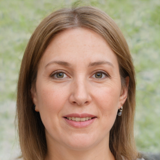 Joyful white adult female with medium  brown hair and grey eyes