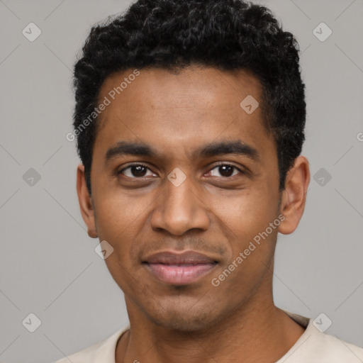 Joyful black young-adult male with short  black hair and brown eyes