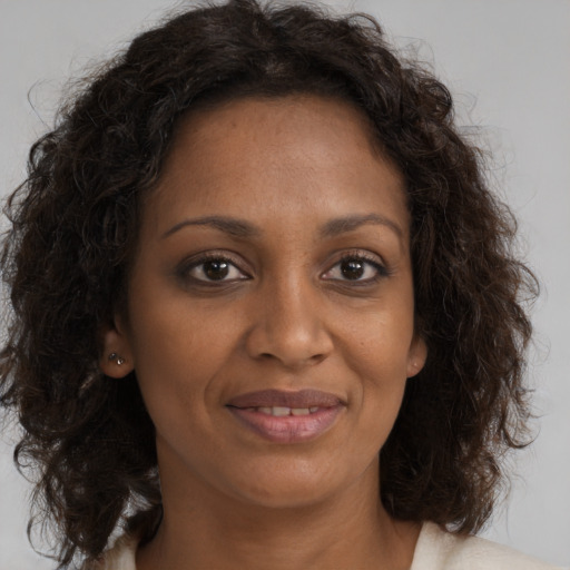 Joyful black young-adult female with medium  brown hair and brown eyes