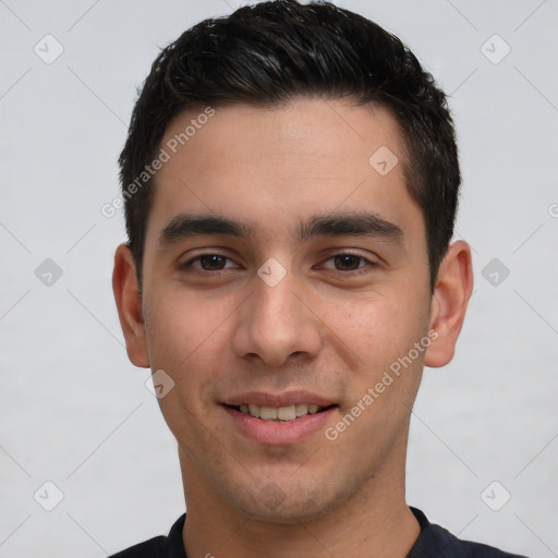 Joyful white young-adult male with short  black hair and brown eyes