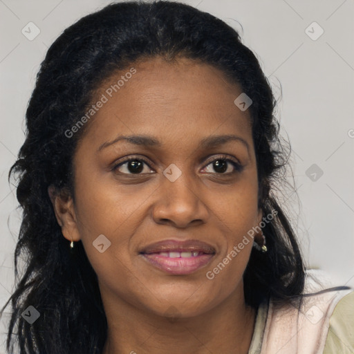 Joyful black young-adult female with long  brown hair and brown eyes