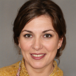 Joyful white young-adult female with medium  brown hair and brown eyes