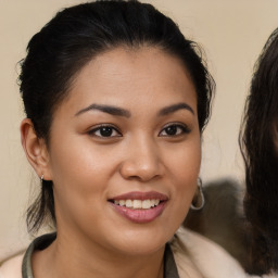 Joyful latino young-adult female with long  brown hair and brown eyes