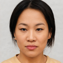 Neutral asian young-adult female with medium  brown hair and brown eyes