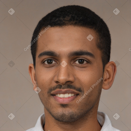 Joyful black young-adult male with short  black hair and brown eyes