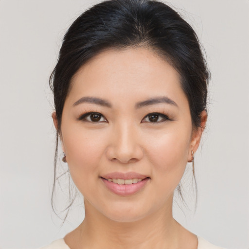 Joyful asian young-adult female with medium  brown hair and brown eyes