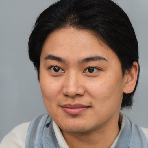 Joyful asian young-adult female with medium  brown hair and brown eyes
