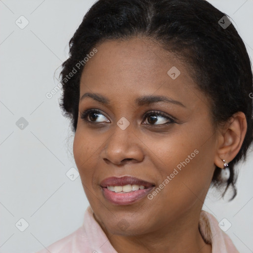 Joyful black young-adult female with medium  brown hair and brown eyes