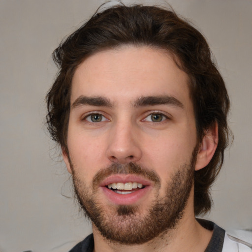 Joyful white young-adult male with medium  brown hair and brown eyes