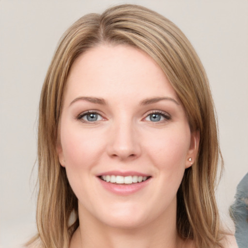 Joyful white young-adult female with long  brown hair and blue eyes