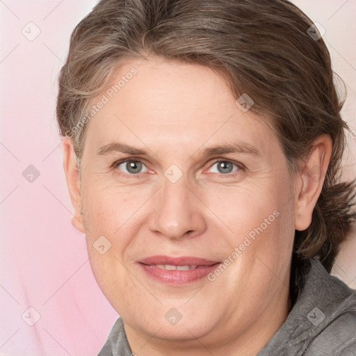 Joyful white adult female with medium  brown hair and brown eyes