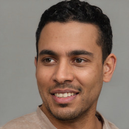 Joyful latino young-adult male with short  black hair and brown eyes