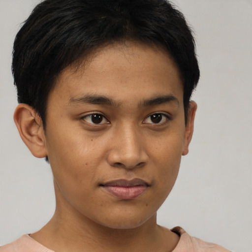 Joyful latino young-adult male with short  brown hair and brown eyes