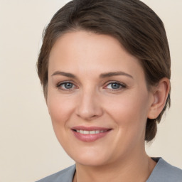 Joyful white young-adult female with medium  brown hair and grey eyes