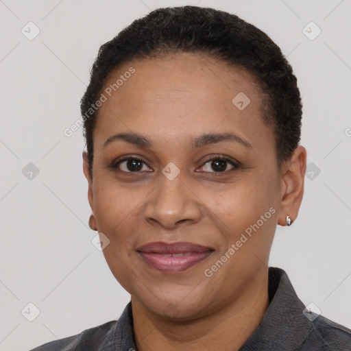 Joyful black adult female with short  black hair and brown eyes