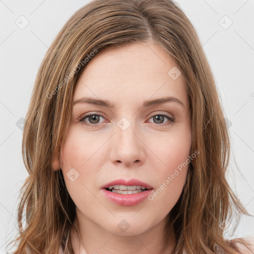 Joyful white young-adult female with long  brown hair and green eyes