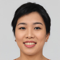 Joyful asian young-adult female with short  black hair and brown eyes