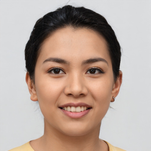 Joyful latino young-adult female with short  brown hair and brown eyes