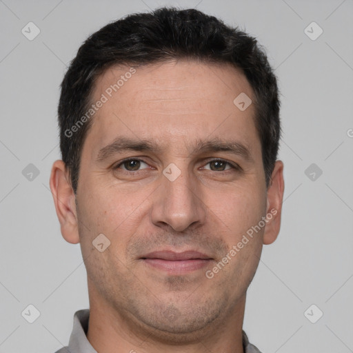 Joyful white adult male with short  brown hair and brown eyes