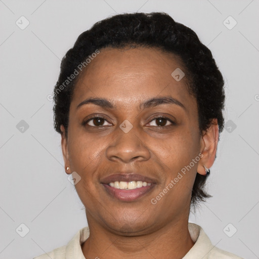 Joyful black adult female with short  black hair and brown eyes