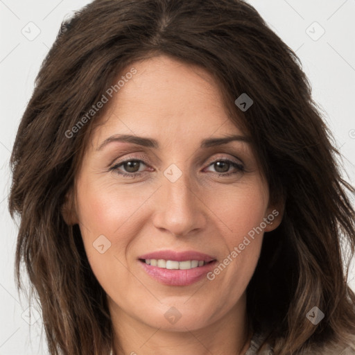 Joyful white adult female with long  brown hair and brown eyes