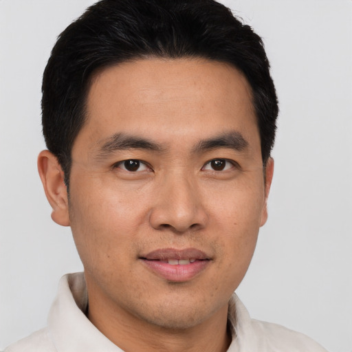 Joyful asian young-adult male with short  black hair and brown eyes