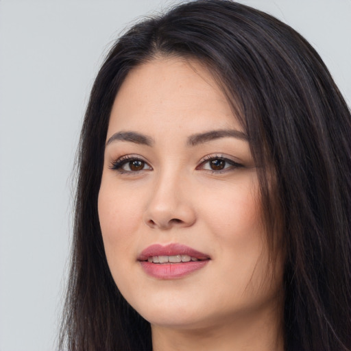 Joyful white young-adult female with long  black hair and brown eyes