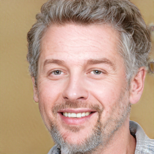 Joyful white adult male with short  brown hair and grey eyes