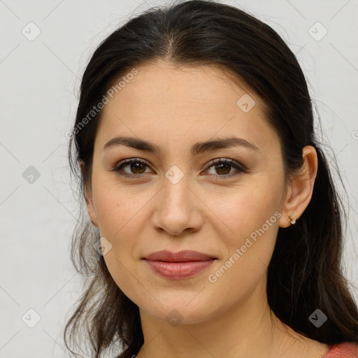 Joyful white young-adult female with long  brown hair and brown eyes