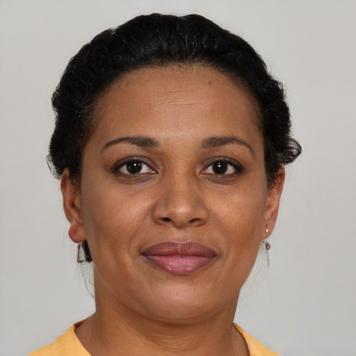 Joyful latino adult female with short  brown hair and brown eyes