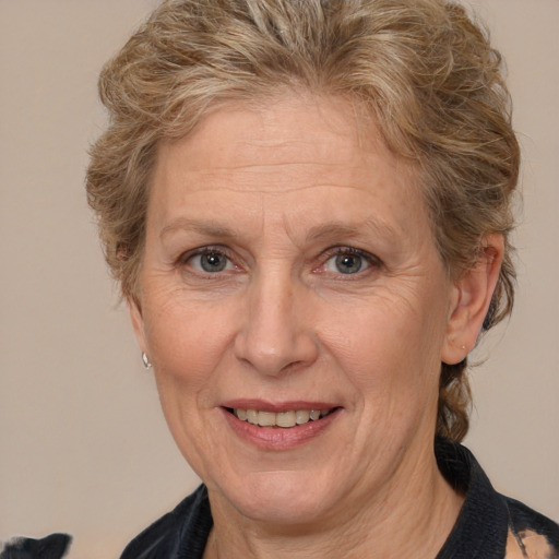 Joyful white middle-aged female with medium  brown hair and brown eyes